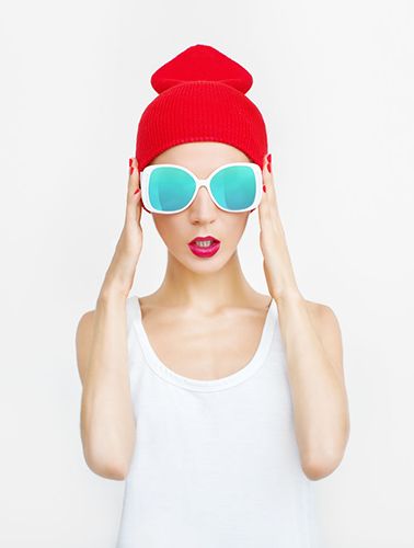 cool looking woman with sunglasses and a hat